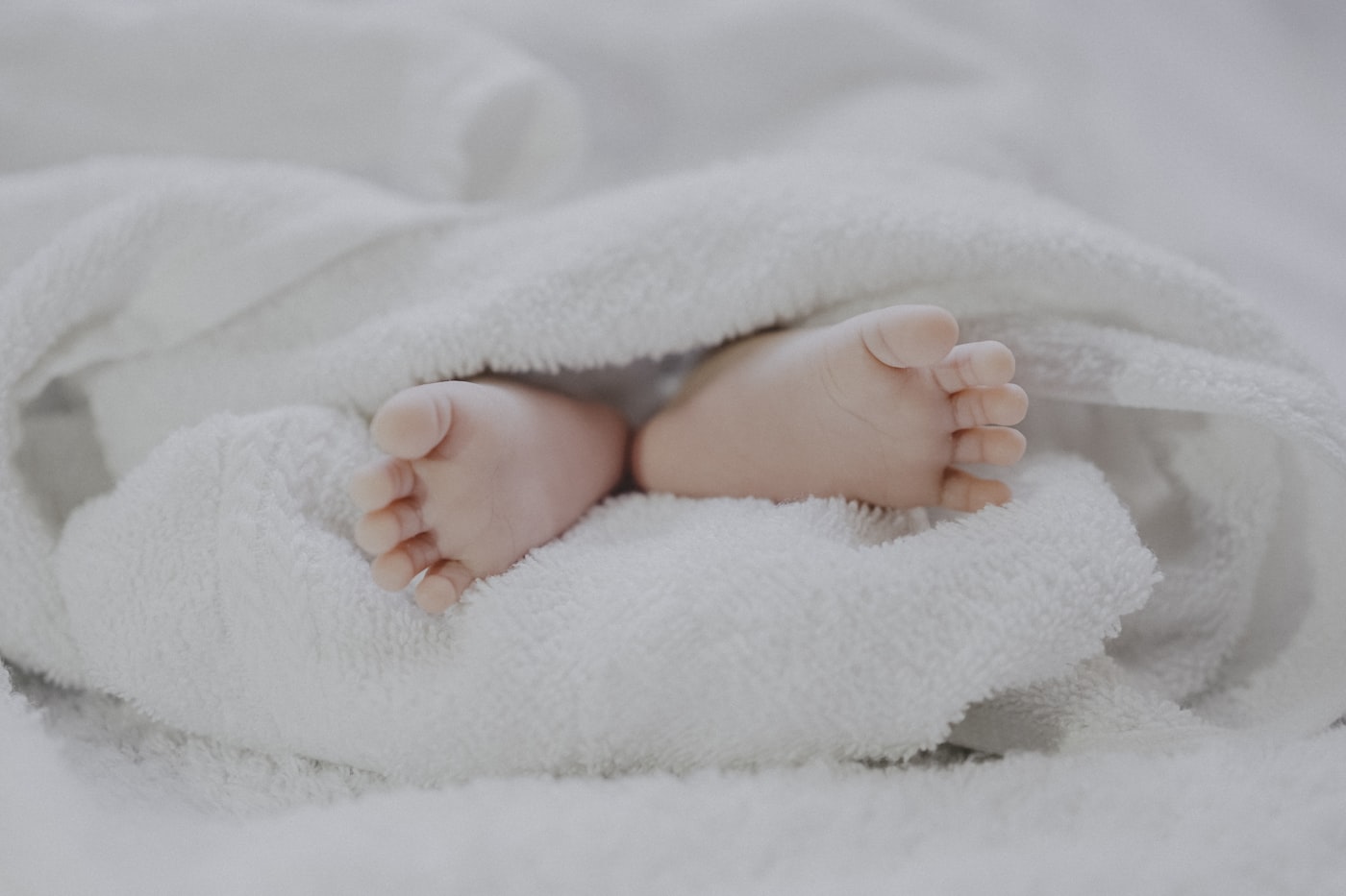 Baby feet wrapped in a soft towel